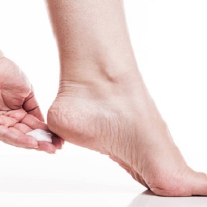 Applying foot cream to heel of healthy foot