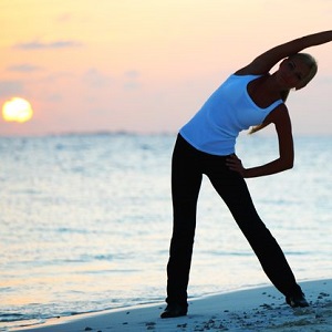 Lifestyle yoga on beach at sunset